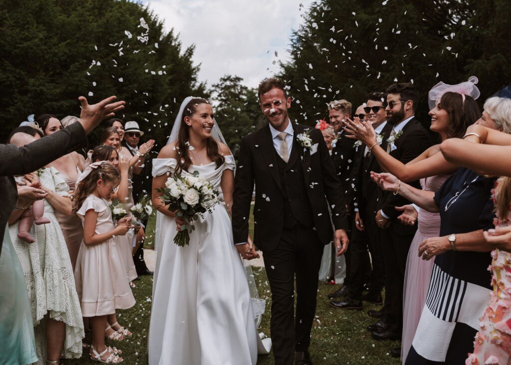 A couple shares an emotional first look at the aisle in a romantic French château, surrounded by timeless elegance.