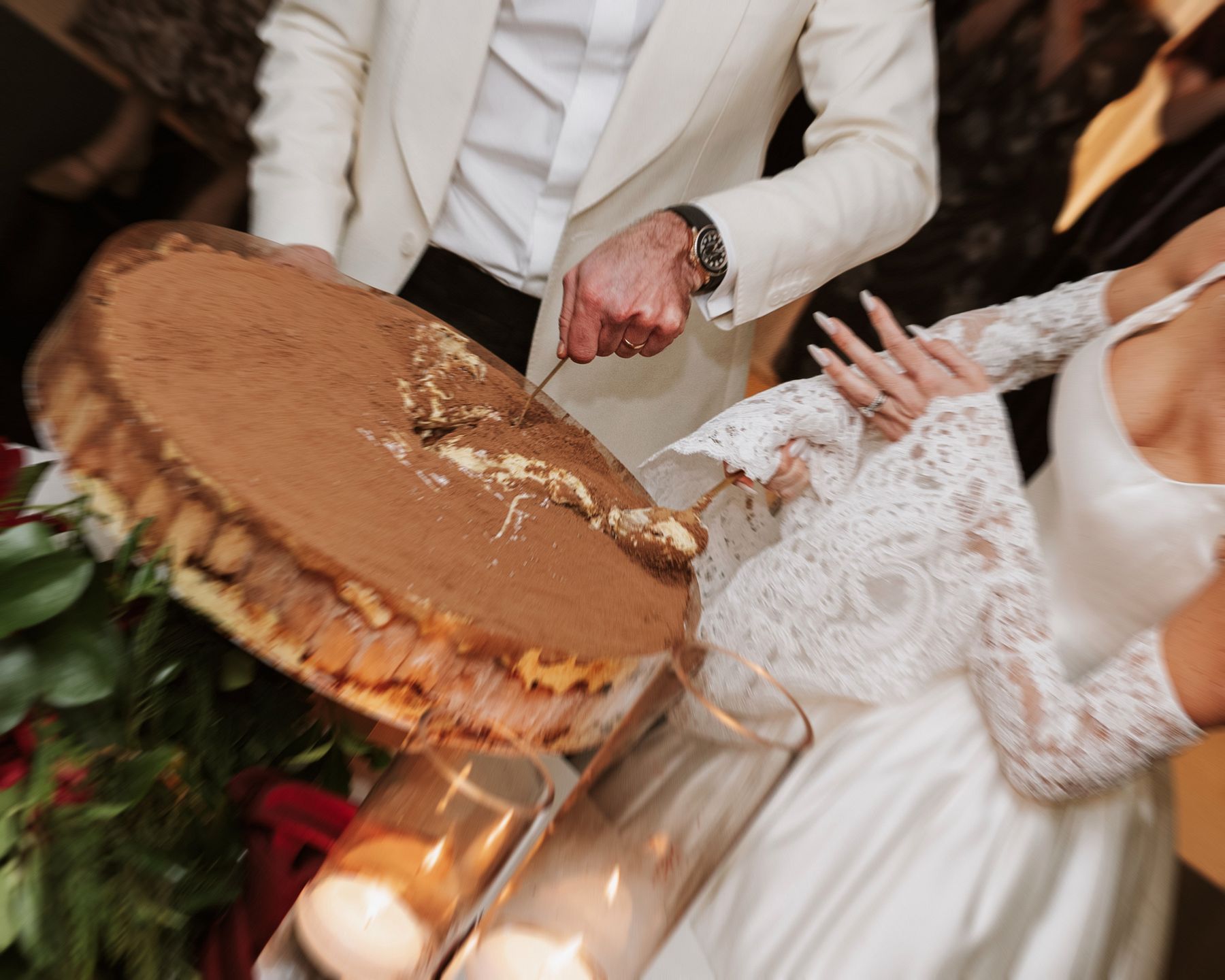 Couple cutting their wedding tiramisu before the first dance in their wedding reception in Essex